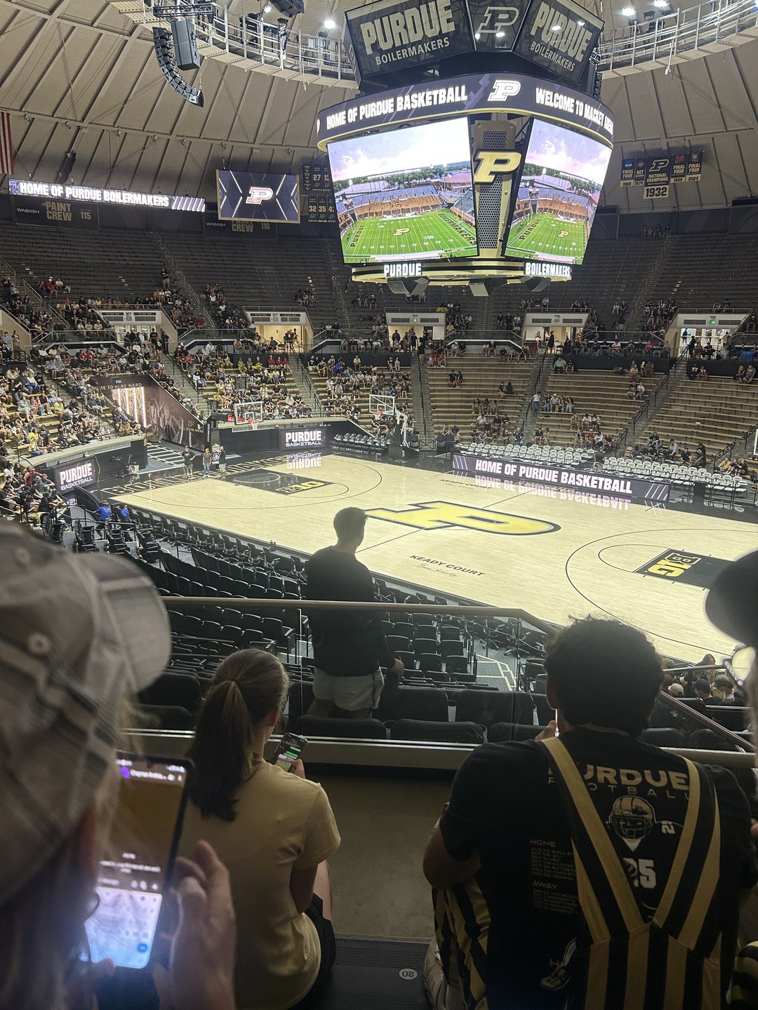 Fans gathered inside Mackey Arena while football plays on the center video boards during the September 13, 2025 weather delay.